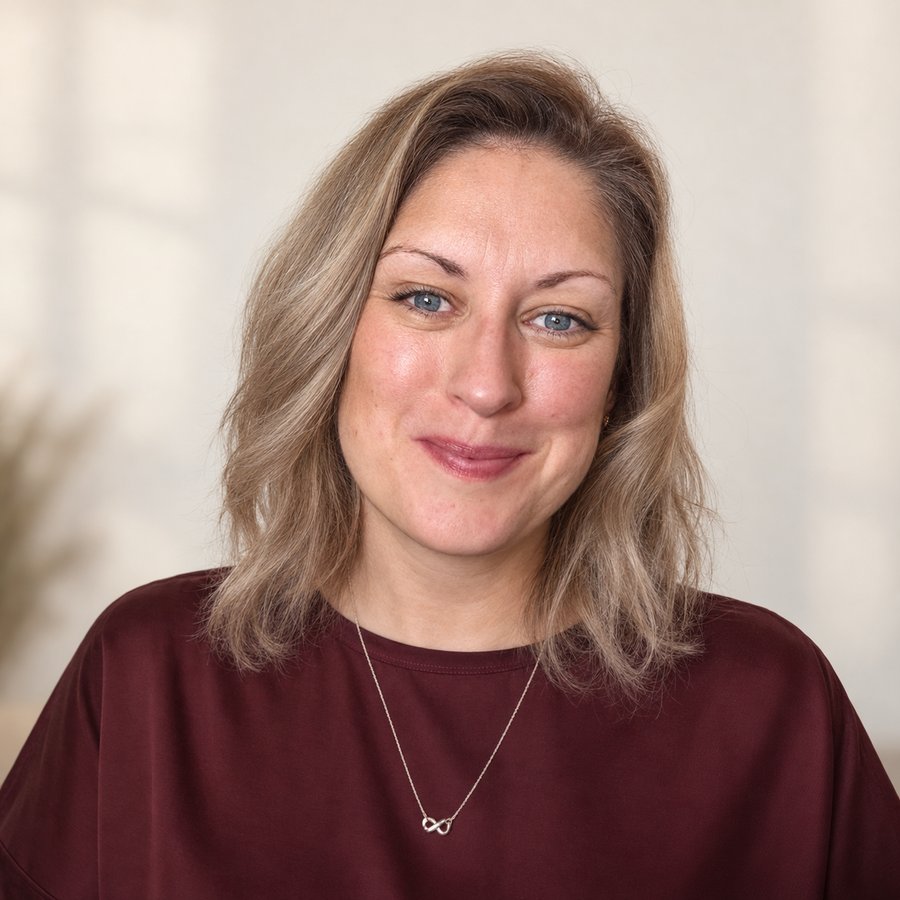 Rebecca Cooper, founder of Elevatus Coaching, smiling in a burgundy top